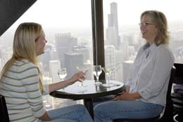 Stacey Green (left) and Michelle Crawfod, of Jacksonville, Florida, enjoy a drink and view of the city at the Signature Lounge of the John Hancock Center, 875 N Michigan Ave